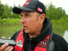 Jared on the phone at the water in his AWP Search Team vest